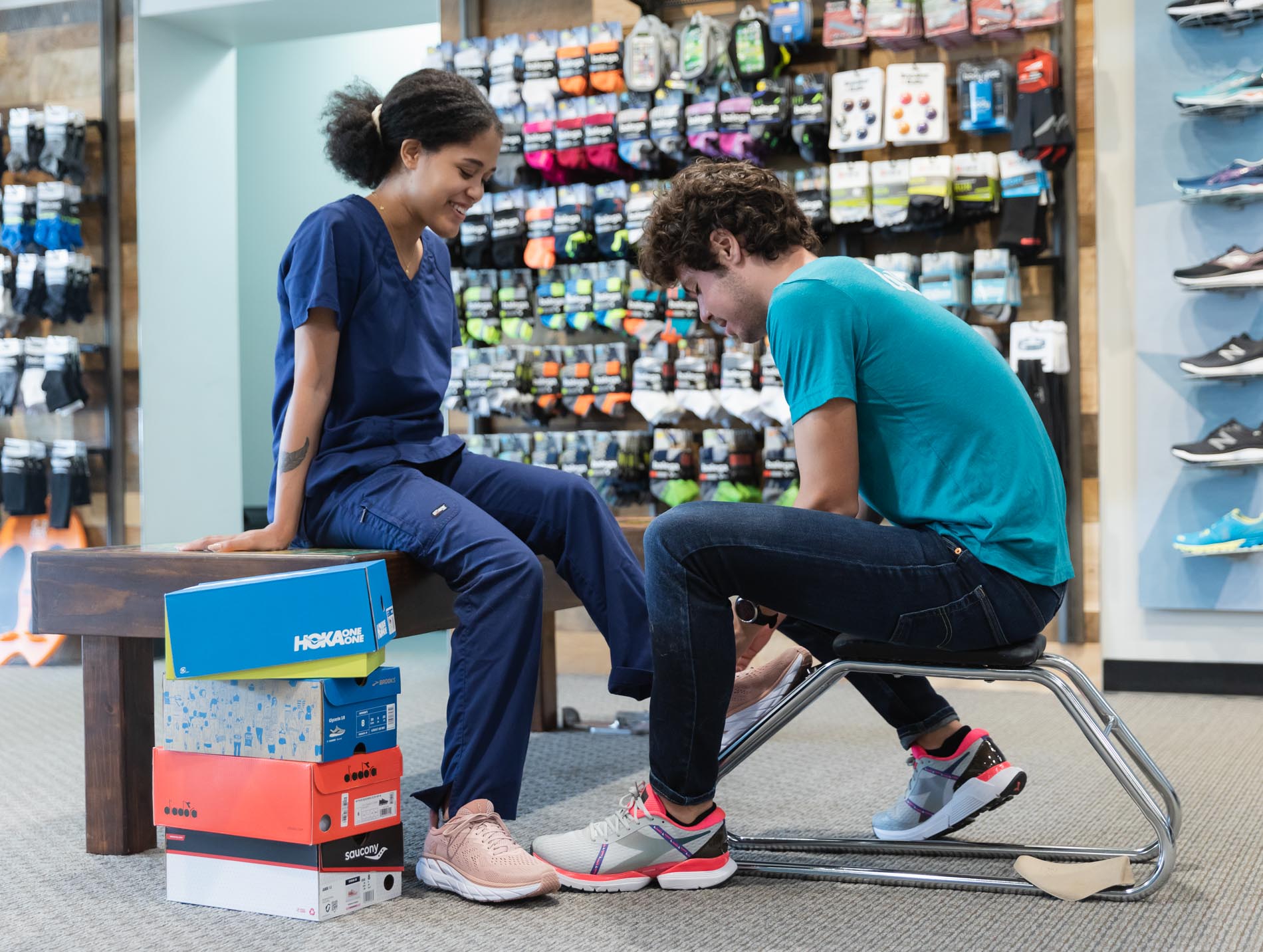 running well employee helping nurse try on shoes for standing and walking