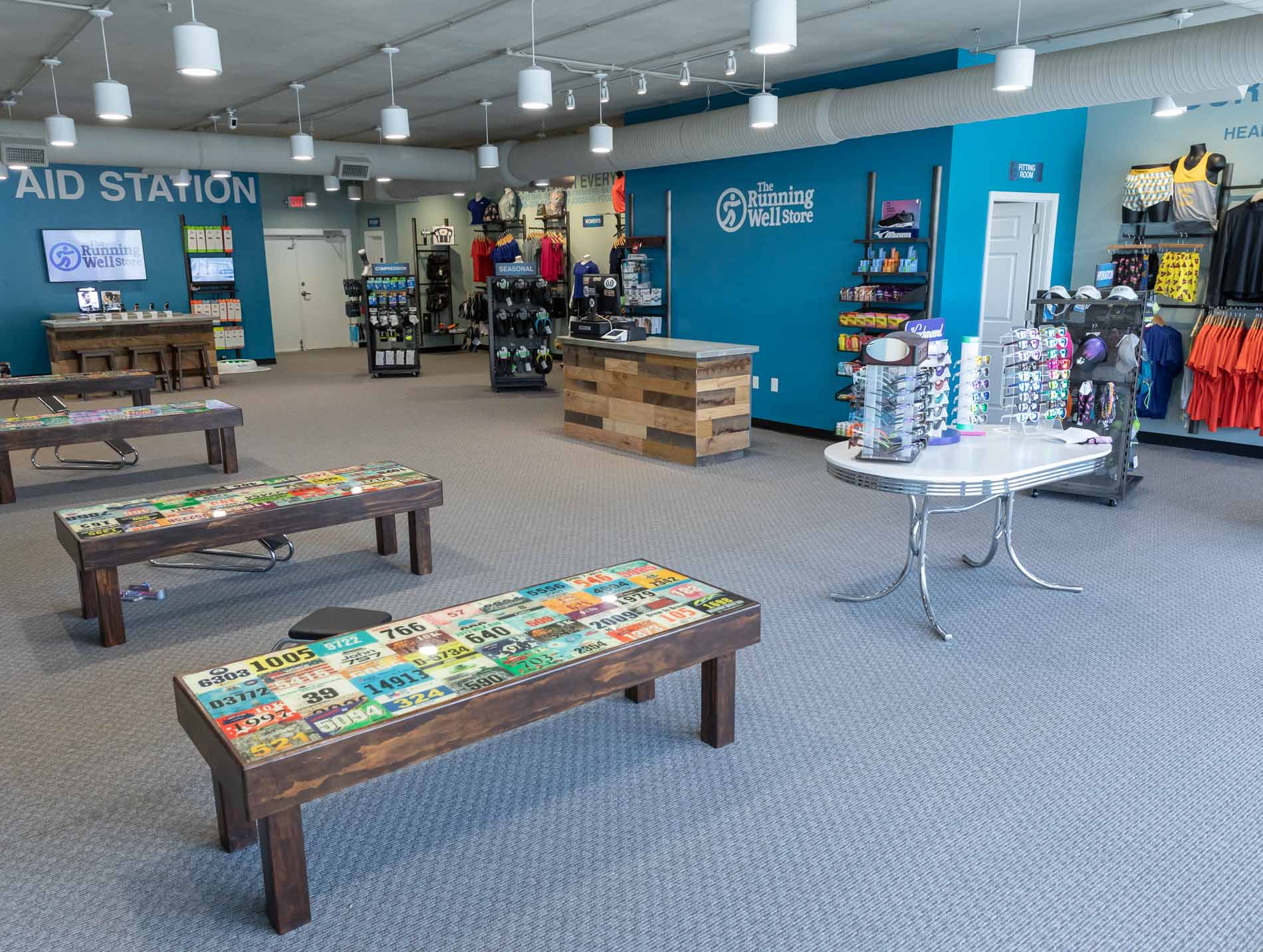 image of the running well store interior - featuring workout clothes, sunglasses, and more