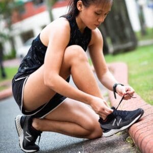 Woman Tying Laces On Her New Balance 880V11